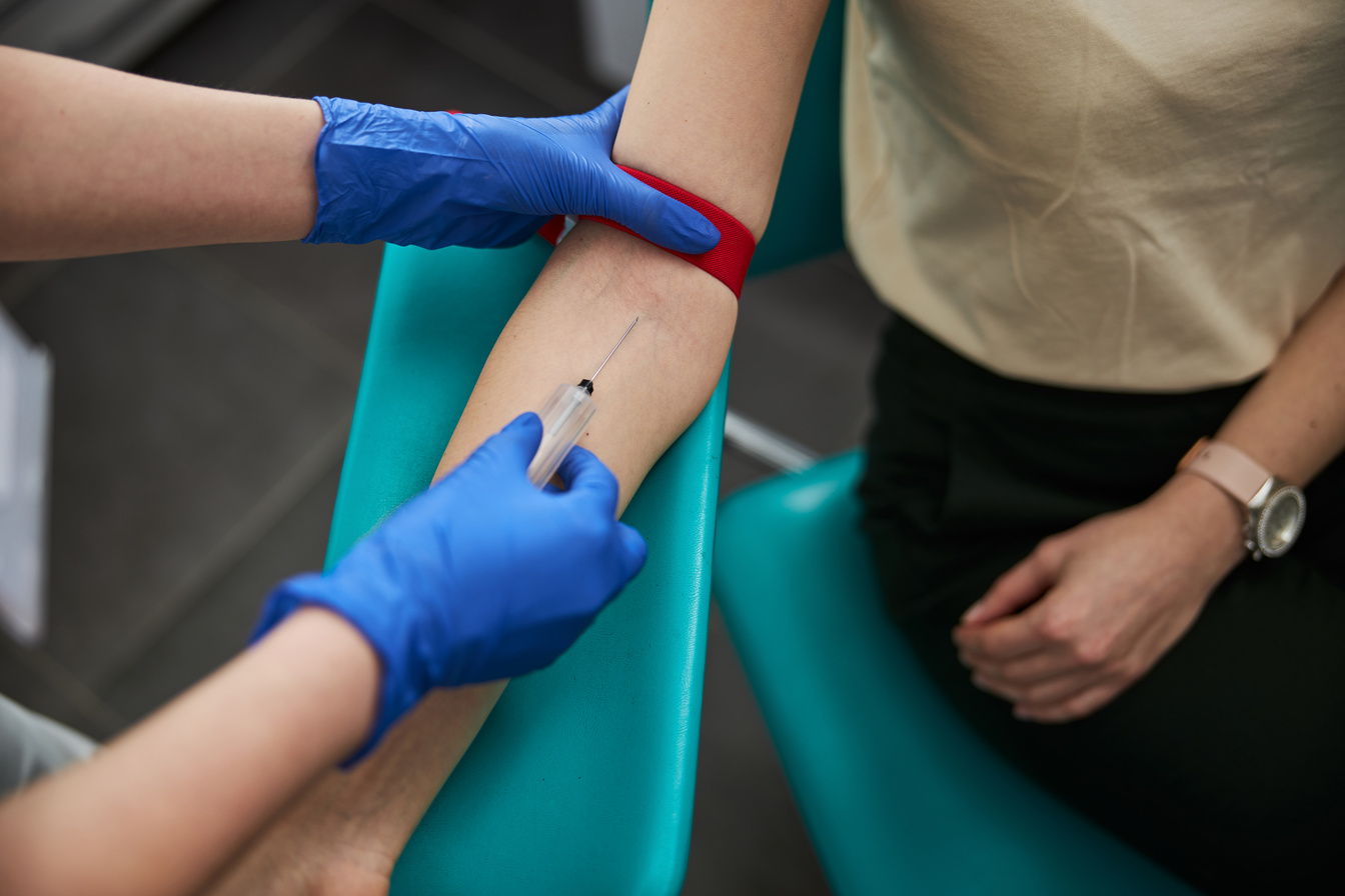 Phlebotomist drawing blood for a laboratory test
